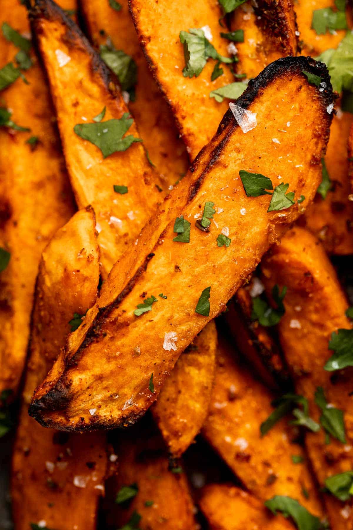 Baked Sweet Potato Wedges are crispy, delicious, flavorful. Serve as an appetizer or side dish. They are salty, savory, and sweet, with a hint of spice. | aheadofthyme.com