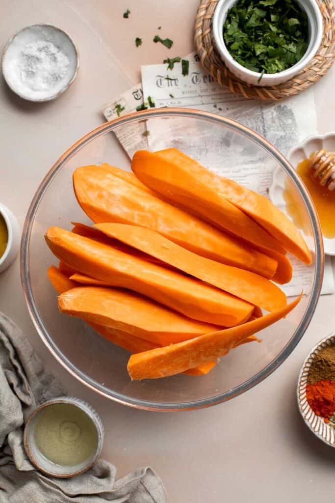 Baked Sweet Potato Wedges are crispy, delicious, flavorful. Serve as an appetizer or side dish. They are salty, savory, and sweet, with a hint of spice. | aheadofthyme.com