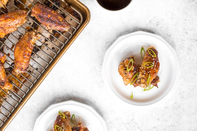 You will be amazed by how crispy these baked Asian chicken wings turn out! We add sriracha for heat, honey for sweetness, and ginger to balance the flavours. | aheadofthyme.com