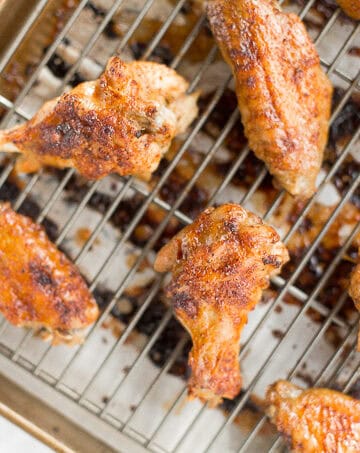 You will be amazed by how crispy these baked Asian chicken wings turn out! We add sriracha for heat, honey for sweetness, and ginger to balance the flavours. | aheadofthyme.com