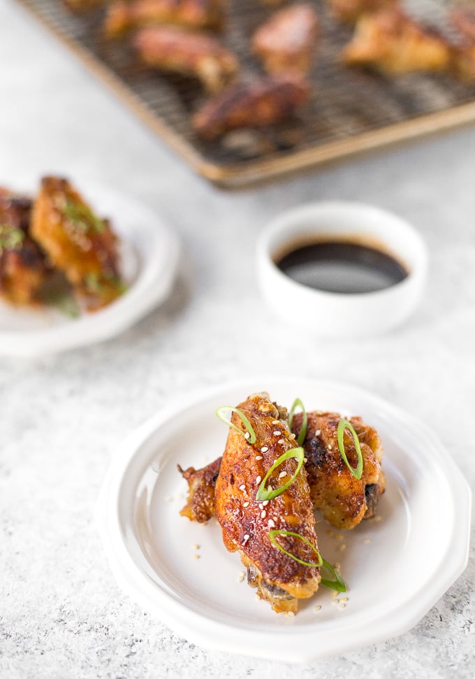 You will be amazed by how crispy these baked Asian chicken wings turn out! We add sriracha for heat, honey for sweetness, and ginger to balance the flavours. | aheadofthyme.com