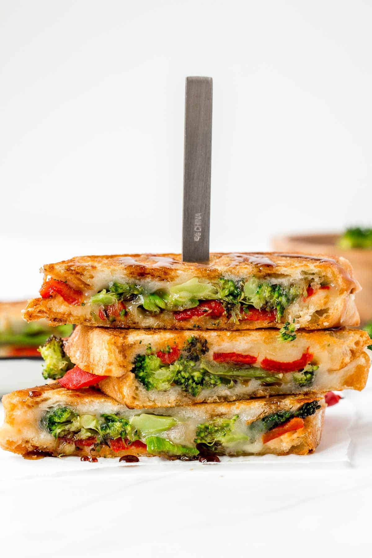 Take your grilled cheese game to the next level with Roasted Broccoli Grilled Cheese Sandwich made with broccoli, red peppers, cheddar, and mozzarella. | aheadofthyme.com