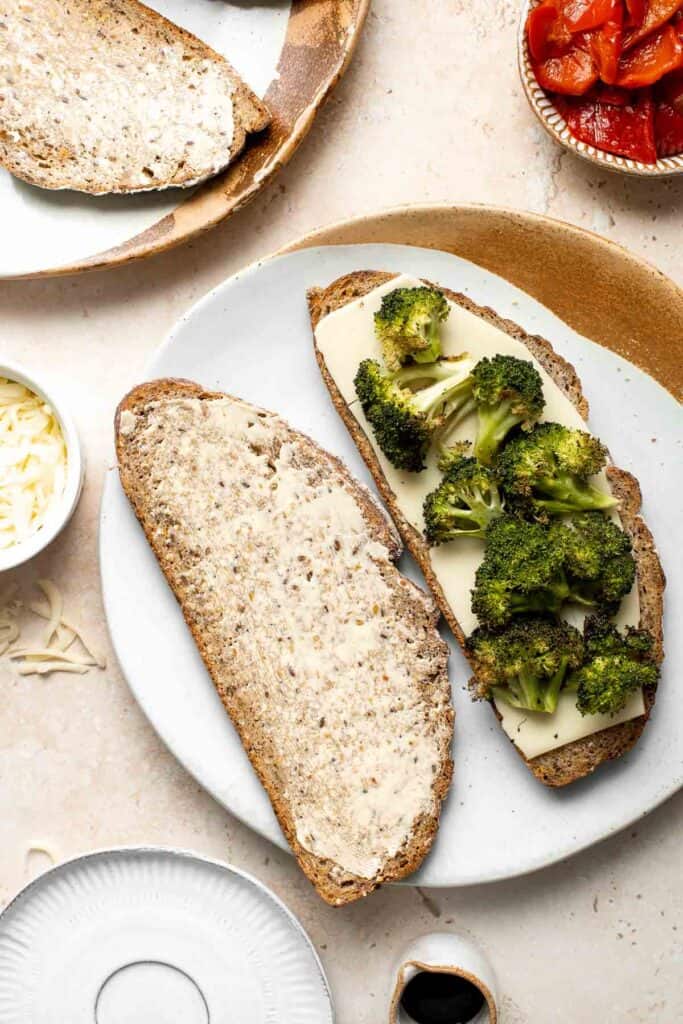 Take your grilled cheese game to the next level with Roasted Broccoli Grilled Cheese Sandwich made with broccoli, red peppers, cheddar, and mozzarella. | aheadofthyme.com