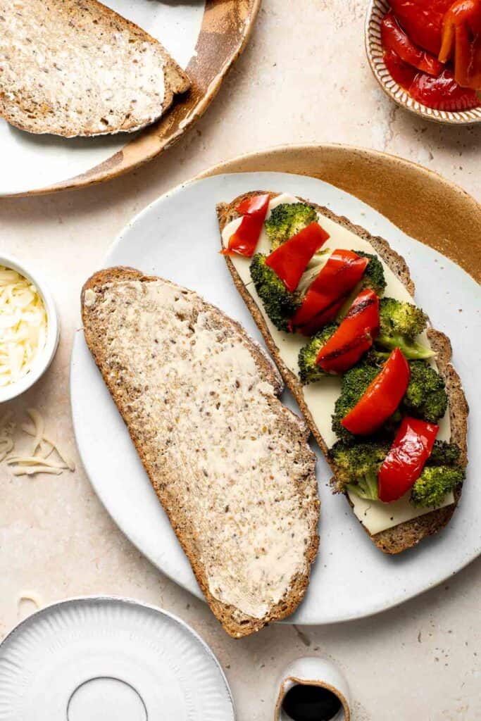 Take your grilled cheese game to the next level with Roasted Broccoli Grilled Cheese Sandwich made with broccoli, red peppers, cheddar, and mozzarella. | aheadofthyme.com