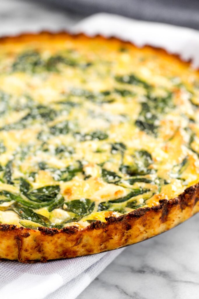 Spinach and feta quiche is healthy and gluten-free with a keto cauliflower crust and savoury vegetarian filling. Serve for breakfast, lunch or dinner. | aheadofthyme.com