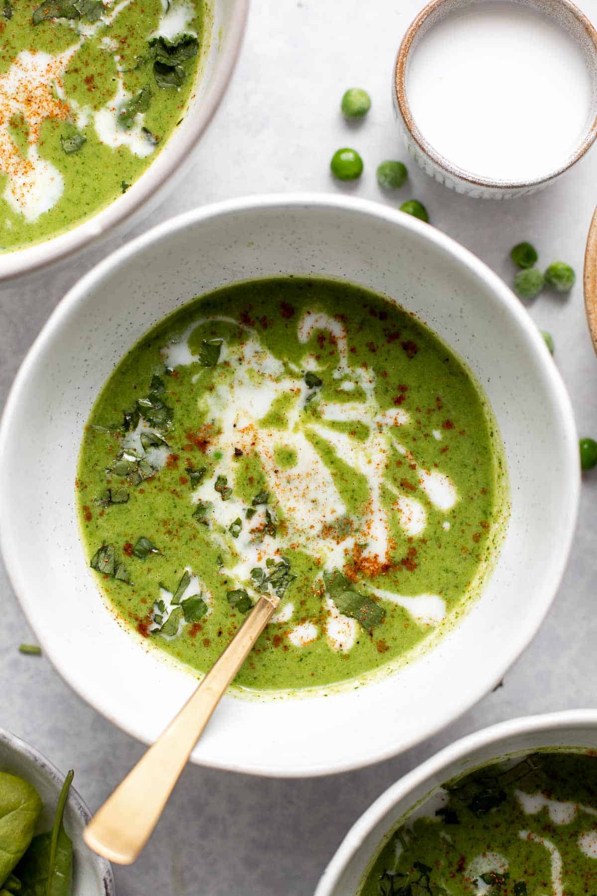 Spinach and Pea Soup is creamy, velvety, healthy and delicious. It's a curried soup with a vegan coconut milk base loaded with fresh spinach and green peas. | aheadofthyme.com