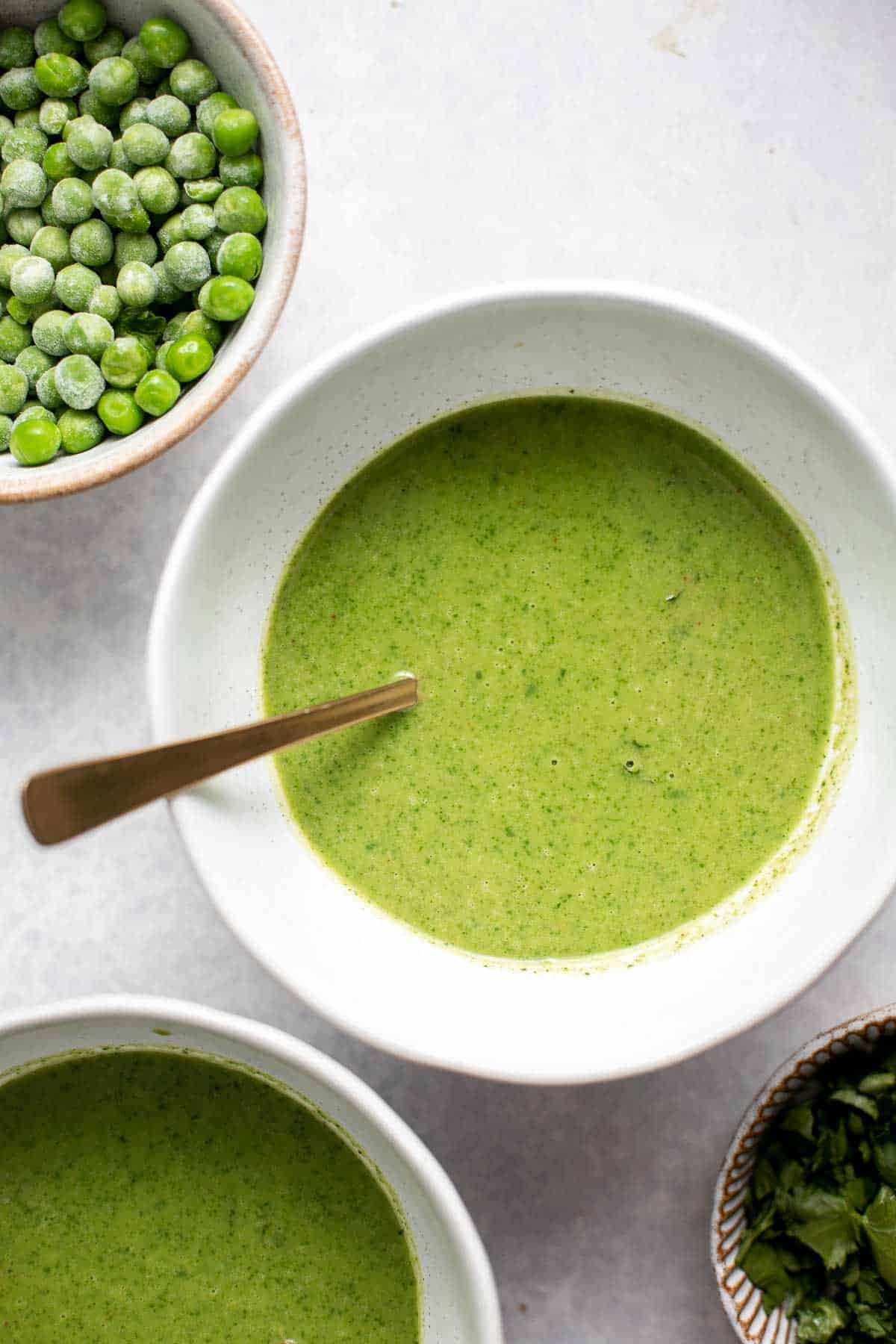 Spinach and Pea Soup is creamy, velvety, healthy and delicious. It's a curried soup with a vegan coconut milk base loaded with fresh spinach and green peas. | aheadofthyme.com
