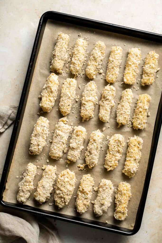 Baked Mozzarella Sticks are a cheesy appetizer that’s crispy on the outside and gooey on the inside. They’re baked instead of fried for a lighter twist. | aheadofthyme.com