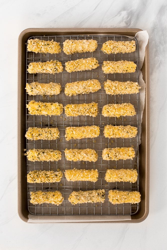 Crunchy, cheesy, and paired with an awesome dipping sauce, these baked mozzarella sticks are just as amazing as what you would find in a restaurant! | aheadofthyme.com