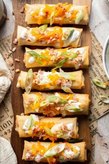 Baked mashed potato spring rolls combine creamy cheesy mashed potatoes with crispy golden wrappers for the ultimate JOEY copycat appetizer. | aheadofthyme.com