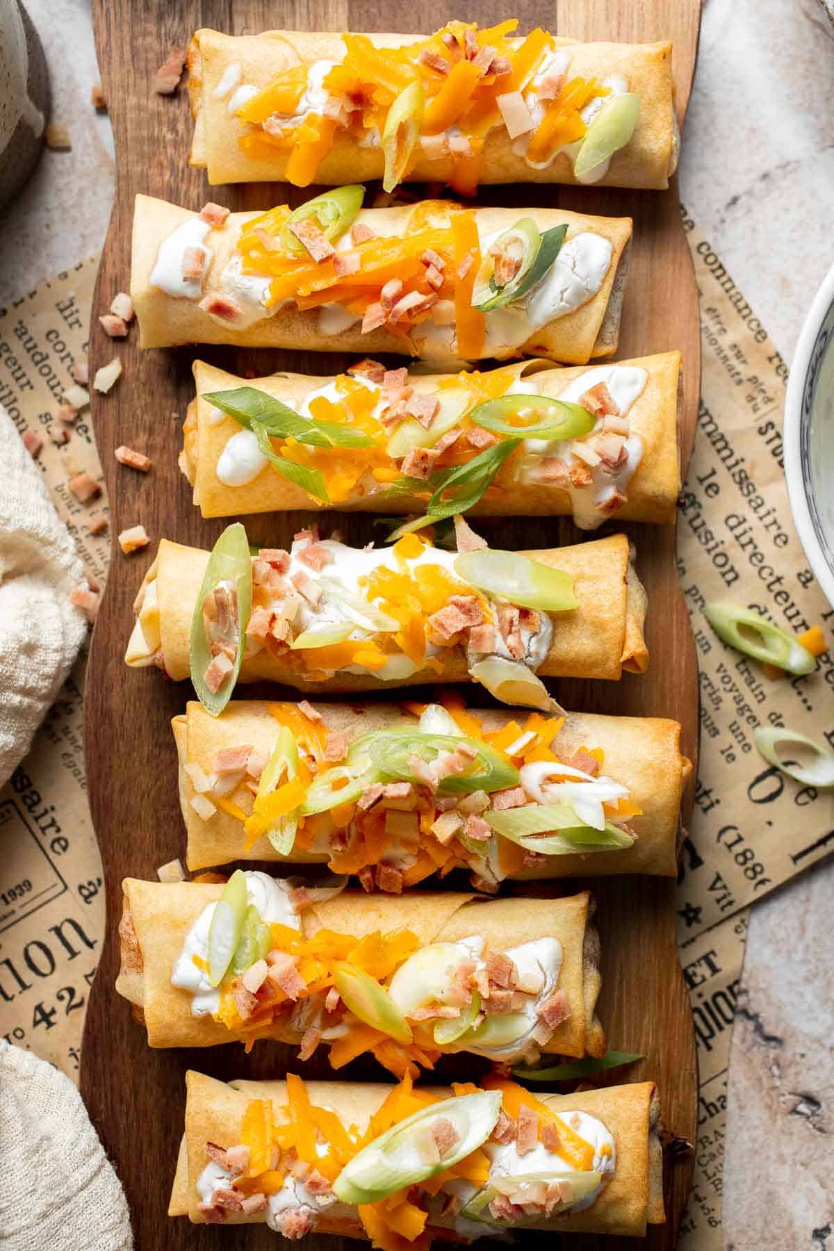 Baked mashed potato spring rolls combine creamy cheesy mashed potatoes with crispy golden wrappers for the ultimate JOEY copycat appetizer. | aheadofthyme.com