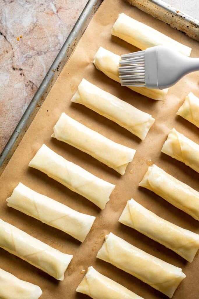 Baked mashed potato spring rolls combine creamy cheesy mashed potatoes with crispy golden wrappers for the ultimate JOEY copycat appetizer. | aheadofthyme.com