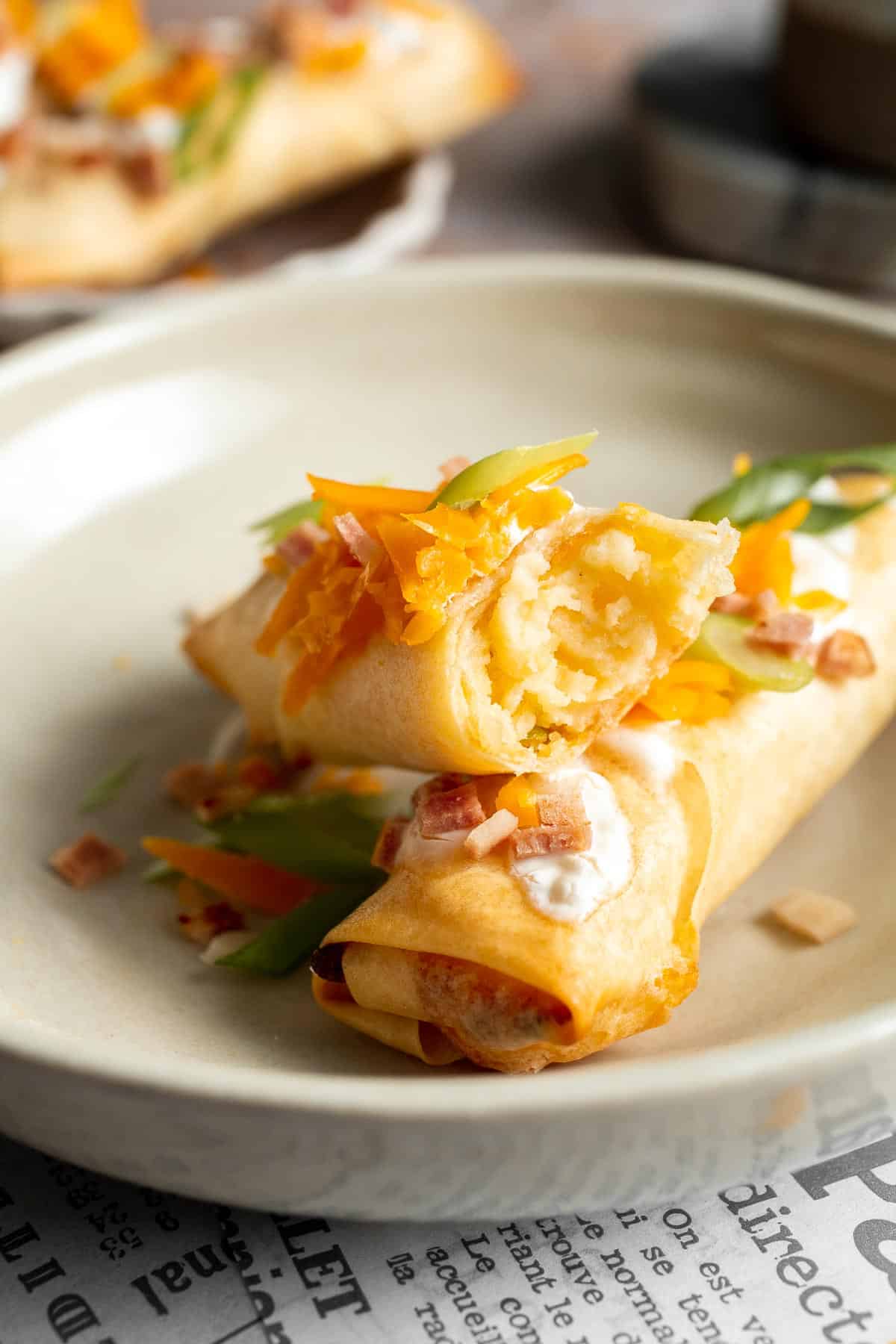 Baked mashed potato spring rolls combine creamy cheesy mashed potatoes with crispy golden wrappers for the ultimate JOEY copycat appetizer. | aheadofthyme.com