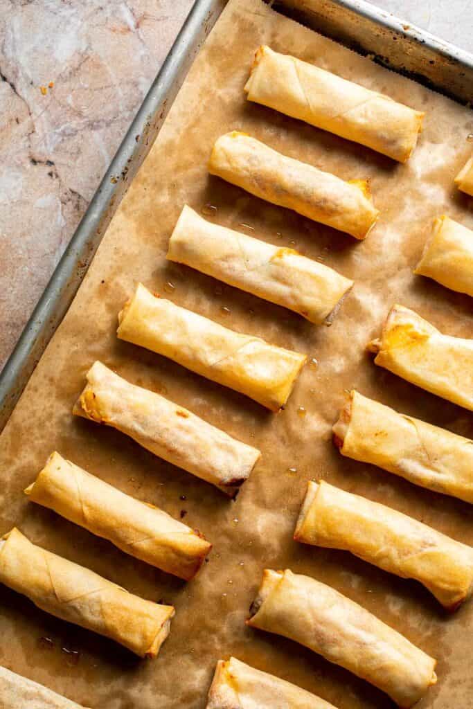 Baked mashed potato spring rolls combine creamy cheesy mashed potatoes with crispy golden wrappers for the ultimate JOEY copycat appetizer. | aheadofthyme.com