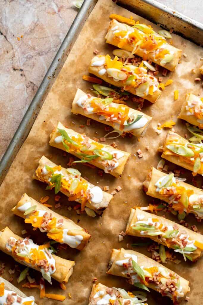 Baked mashed potato spring rolls combine creamy cheesy mashed potatoes with crispy golden wrappers for the ultimate JOEY copycat appetizer. | aheadofthyme.com