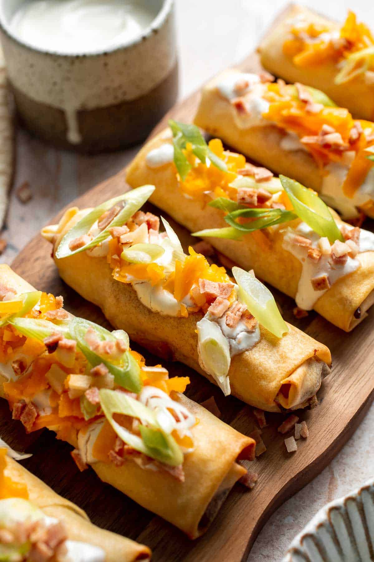 Baked mashed potato spring rolls combine creamy cheesy mashed potatoes with crispy golden wrappers for the ultimate JOEY copycat appetizer. | aheadofthyme.com