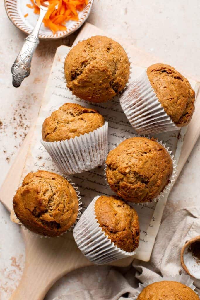 Carrot cake muffins are moist, light, chewy and full of carrots which means breakfast this week is healthy! Carrot muffins are great for meal prep too. | aheadofthyme.com