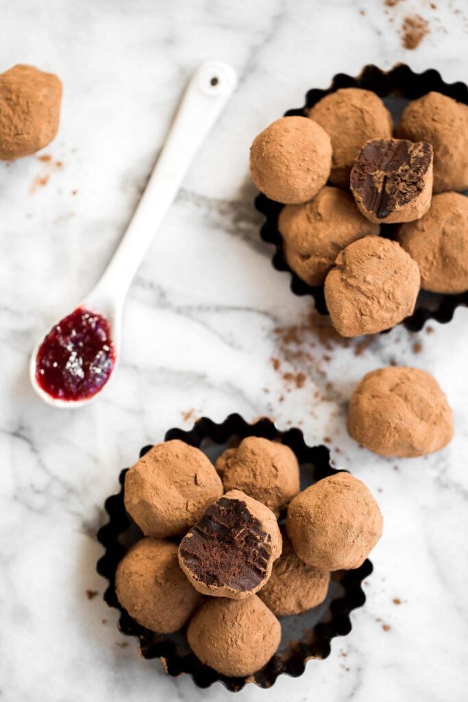 Dark chocolate raspberry truffles are so much easier to make than you think. It's as simple as combining quality chocolate, cream, raspberry jam, and cocoa. | aheadofthyme.com