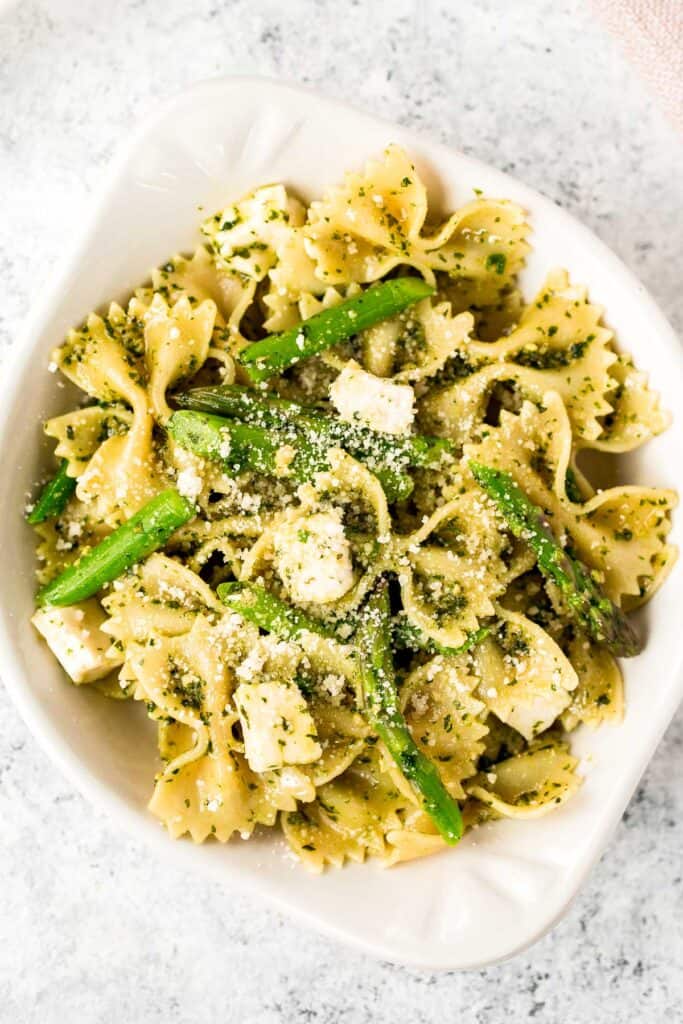 Spring pesto pasta with asparagus and chives is light and made with simple ingredients in under 20 minutes. Serve it hot for dinner or cold as pasta salad. | aheadofthyme.com