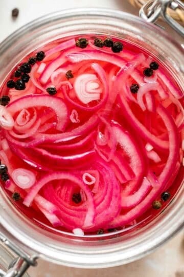 Looking to add some tangy flavor to your meals? Try this simple recipe for pickled red onions that can be made in just a few minutes and stored for weeks! | aheadofthyme.com