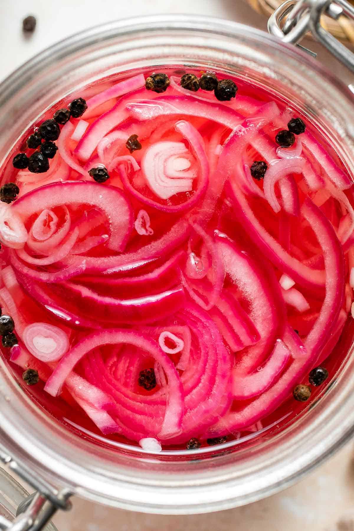 Looking to add some tangy flavor to your meals? Try this simple recipe for pickled red onions that can be made in just a few minutes and stored for weeks! | aheadofthyme.com