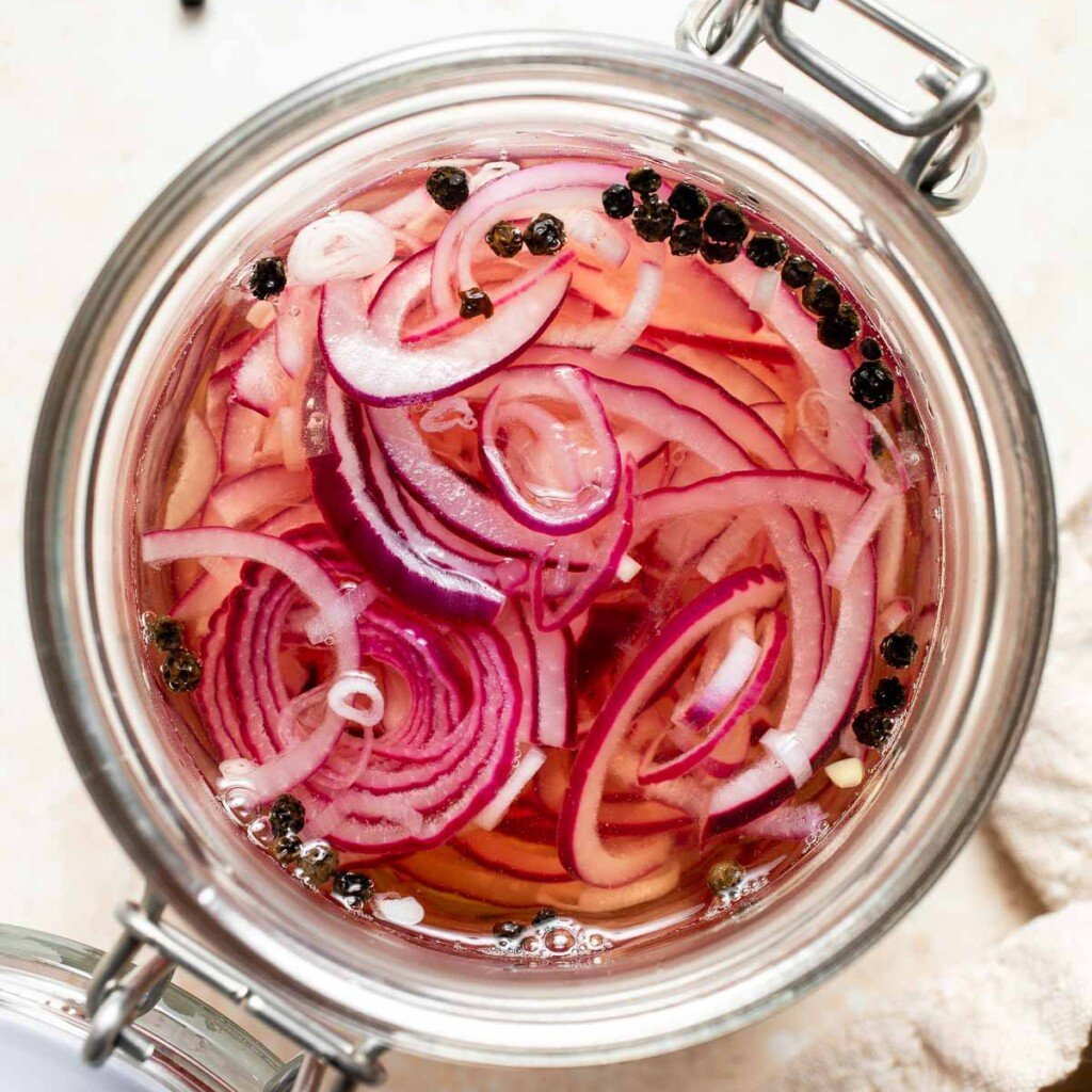 Looking to add some tangy flavor to your meals? Try this simple recipe for pickled red onions that can be made in just a few minutes and stored for weeks! | aheadofthyme.com