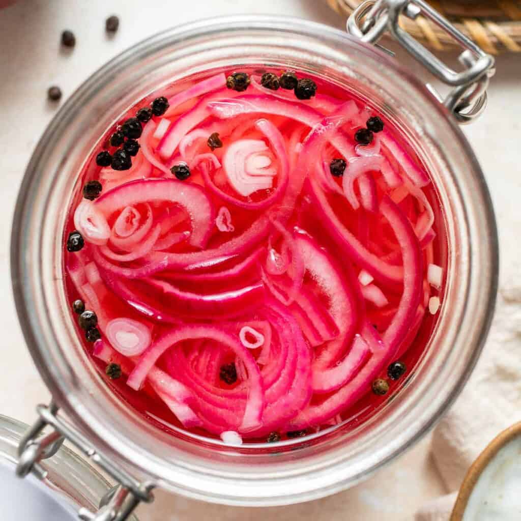 Looking to add some tangy flavor to your meals? Try this simple recipe for pickled red onions that can be made in just a few minutes and stored for weeks! | aheadofthyme.com