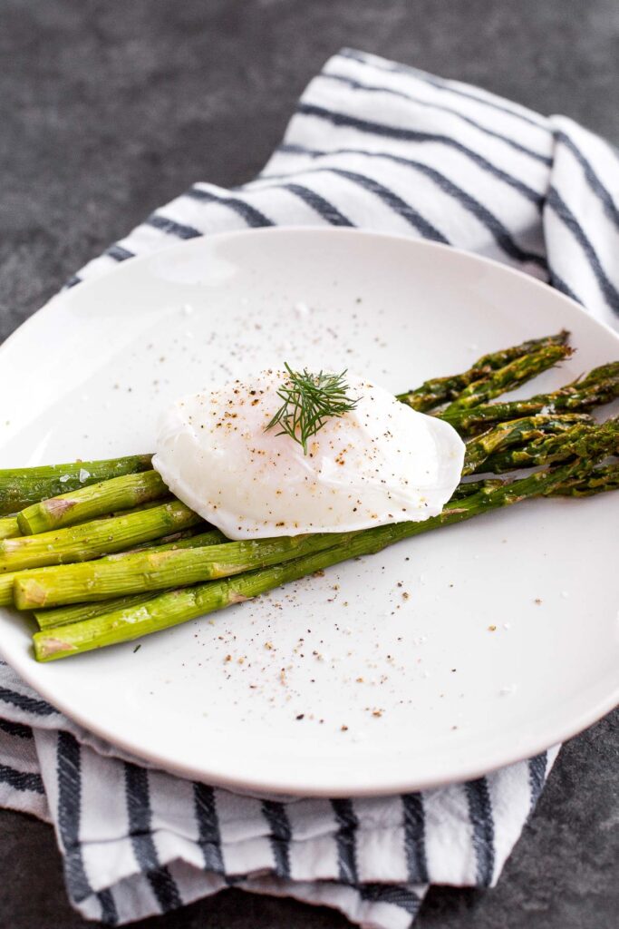 Roasted asparagus with poached eggs and fresh herbs is a classy, elevated spring meal that will leave you feeling light, but completely satisfied. | aheadofthyme.com