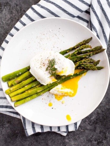 Roasted asparagus with poached eggs and fresh herbs is a classy, elevated spring meal that will leave you feeling light, but completely satisfied. | aheadofthyme.com