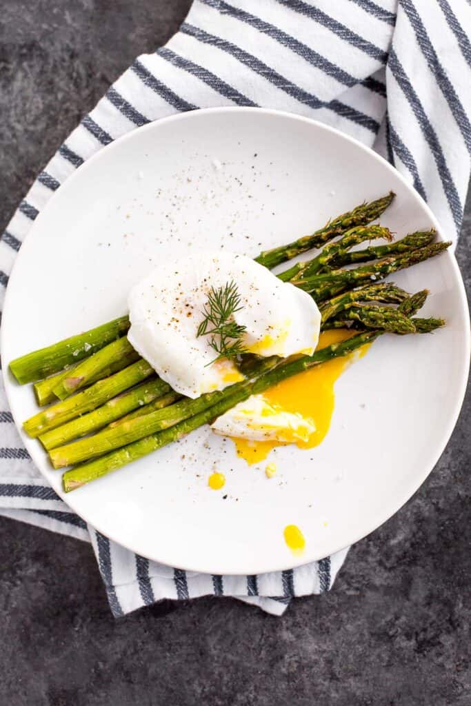 Roasted asparagus with poached eggs and fresh herbs is a classy, elevated spring meal that will leave you feeling light, but completely satisfied. | aheadofthyme.com