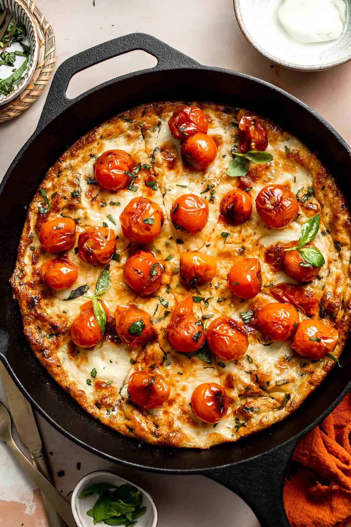 Caprese Frittata is light and fluffy, laced with fresh basil and topped with melted mozzarella cheese and blistered balsamic tomatoes. Ready in 10 minutes! | aheadofthyme.com