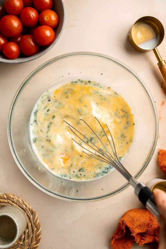 Caprese Frittata is light and fluffy, laced with fresh basil and topped with melted mozzarella cheese and blistered balsamic tomatoes. Ready in 10 minutes! | aheadofthyme.com