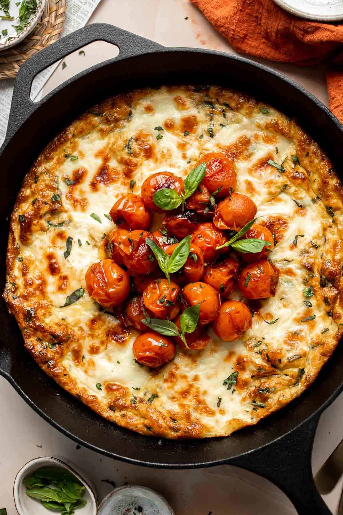 Caprese Frittata is light and fluffy, laced with fresh basil and topped with melted mozzarella cheese and blistered balsamic tomatoes. Ready in 10 minutes! | aheadofthyme.com