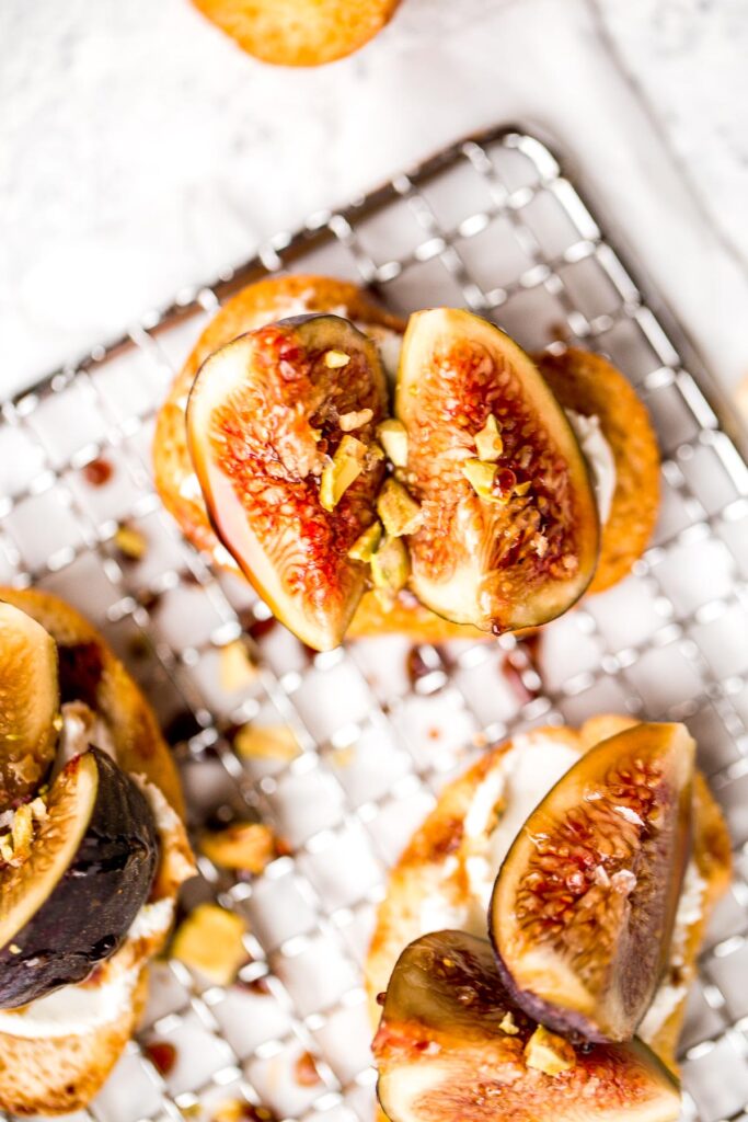 Fig crostini topped sweet, juicy figs, tangy goat cheese and crunchy pistachios is flavourful, delicious, and perfect for snacking on or entertaining. | aheadofthyme.com