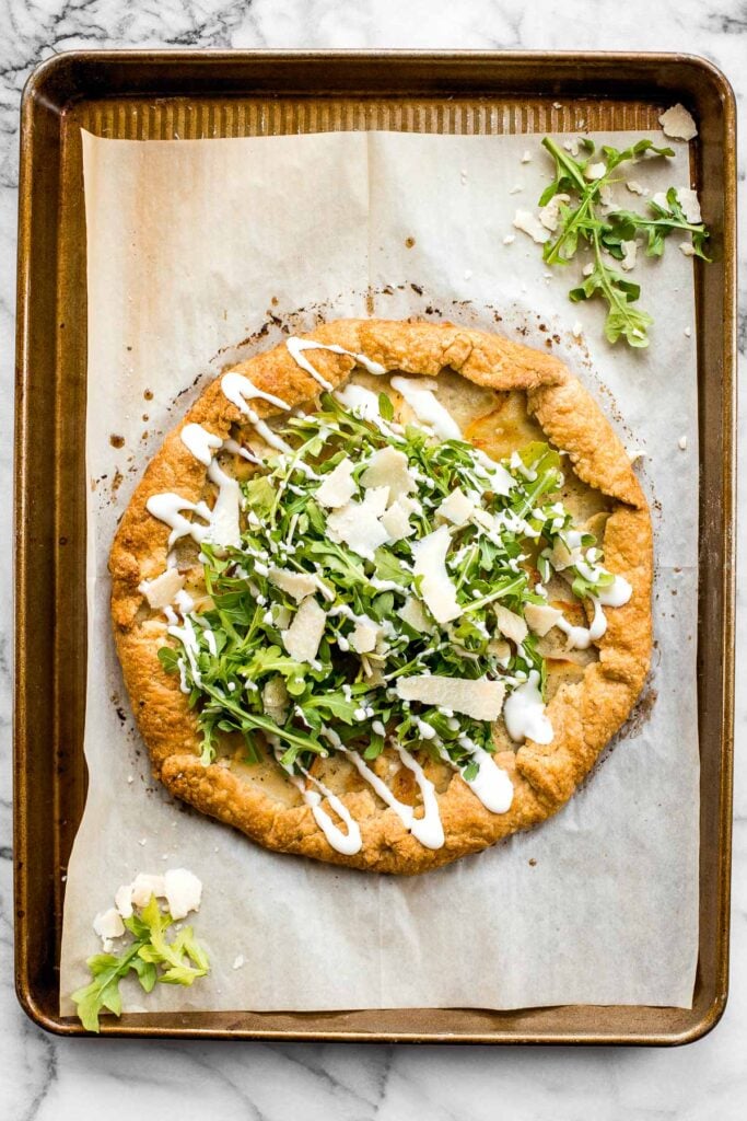 Potato galette with arugula and crème fraîche is a rich, light, and delicious savoury tart to serve for breakfast, lunch, or dinner. A total crowd-pleaser. | aheadofthyme.com