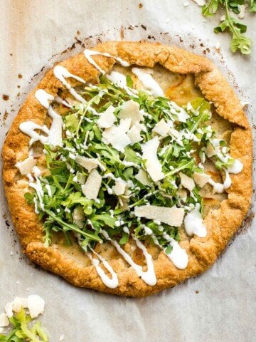 Potato galette with arugula and crème fraîche is a rich, light, and delicious savoury tart to serve for breakfast, lunch, or dinner. A total crowd-pleaser. | aheadofthyme.com
