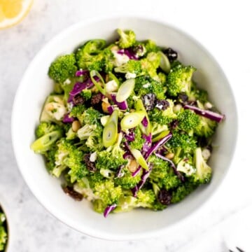 Creamy broccoli slaw salad is healthy, delicious, and flavourful. It's packed with crunchy vegetables, salty feta, sweet raisins, and a creamy dressing. | aheadofthyme.com