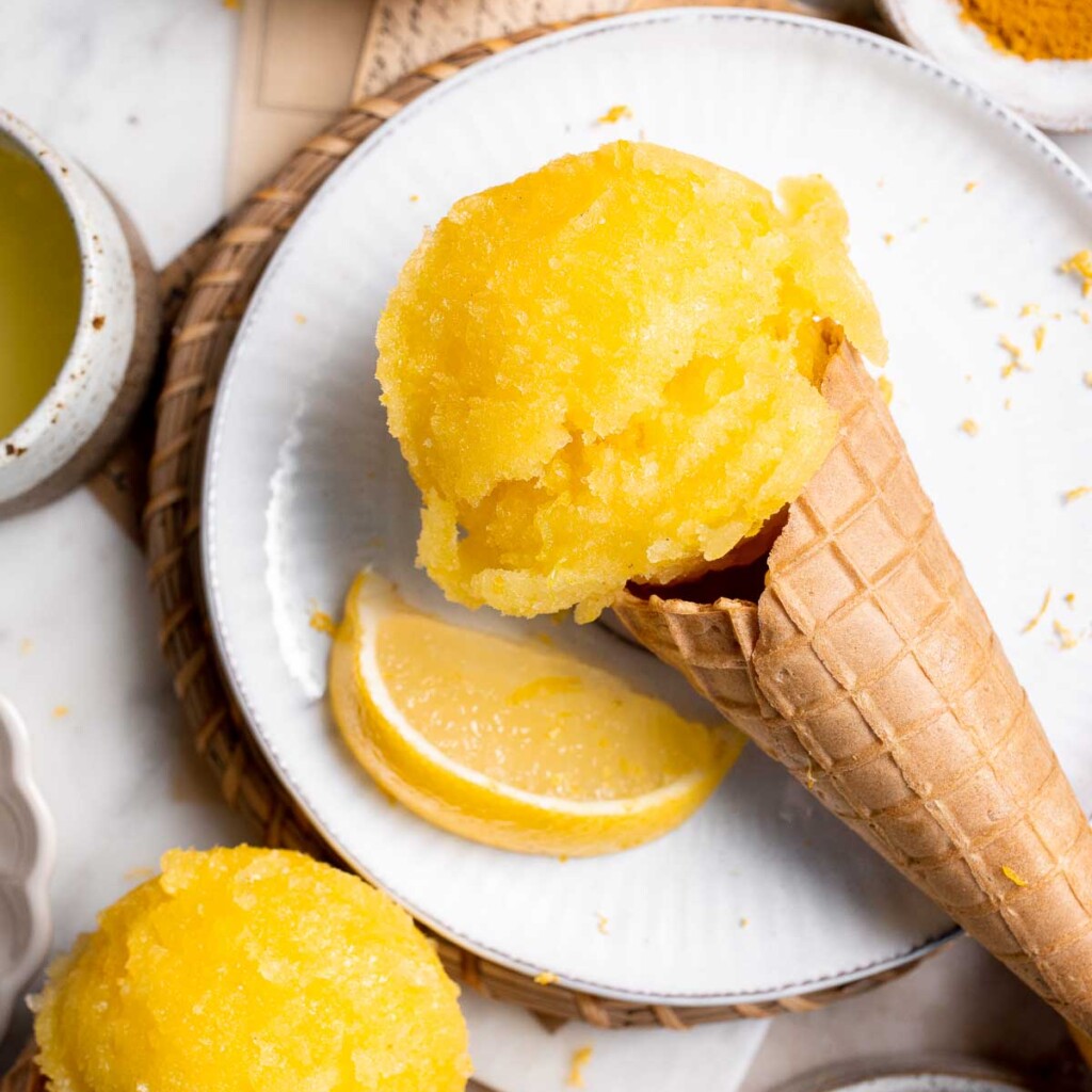 Looking for a refreshing summer treat? Try this easy, all-natural lemon sorbet, made with the added health benefits of turmeric for a bright yellow color. | aheadofthyme.com