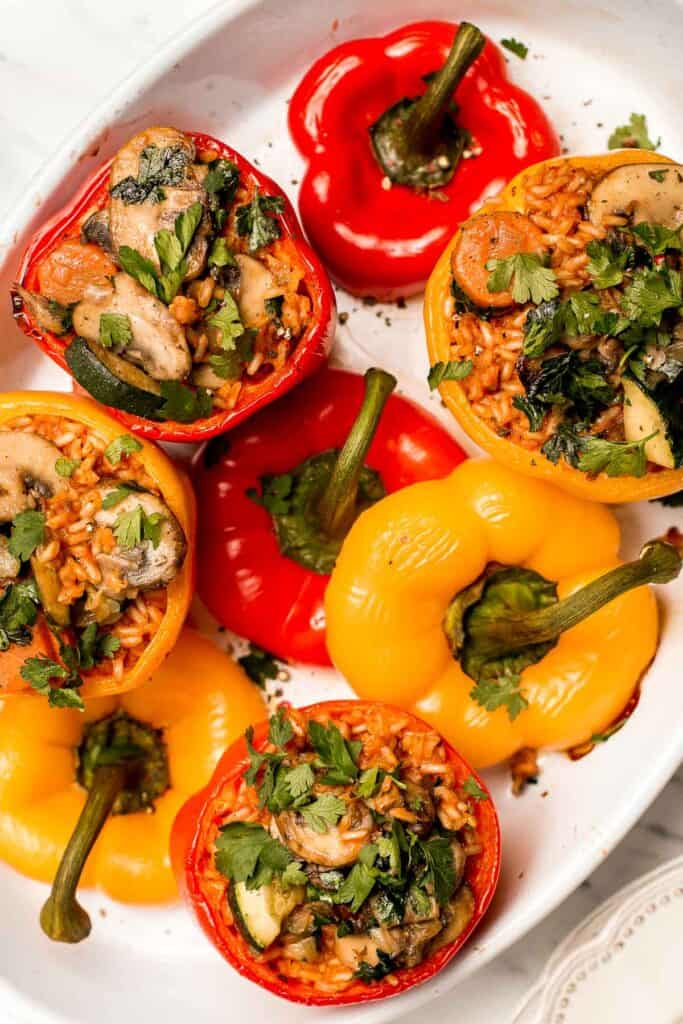 Fresh, homegrown bell peppers baked with an assortment of veggies and brown rice is what these easy vegan stuffed bell peppers are all about!! Ready in under an hour, serve this at your next fancy dinner party or make it for an easy weeknight dinner! | aheadofthyme.com