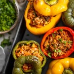 Vegan Stuffed Peppers are stuffed with pan-fried mushrooms, tender rice, and veggies, making them flavorful and filling. Easy to make in under an hour! | aheadofthyme.com