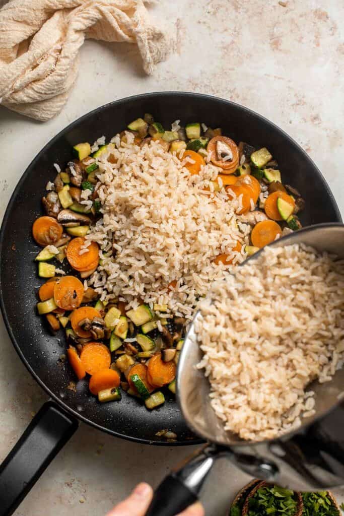 Vegan Stuffed Peppers are stuffed with pan-fried mushrooms, tender rice, and veggies, making them flavorful and filling. Easy to make in under an hour! | aheadofthyme.com