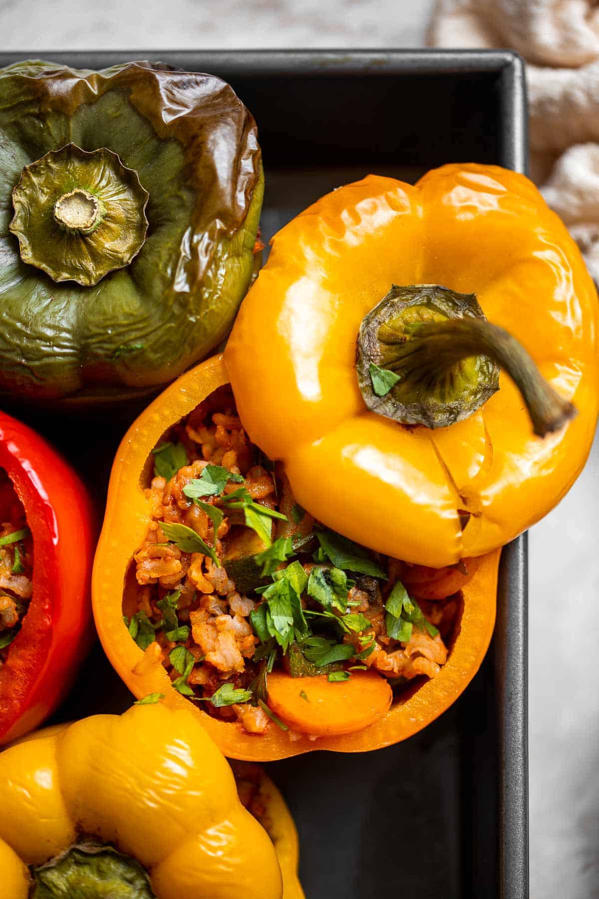 Vegan Stuffed Peppers are stuffed with pan-fried mushrooms, tender rice, and veggies, making them flavorful and filling. Easy to make in under an hour! | aheadofthyme.com