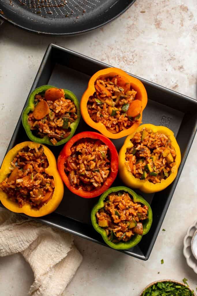 Vegan Stuffed Peppers are stuffed with pan-fried mushrooms, tender rice, and veggies, making them flavorful and filling. Easy to make in under an hour! | aheadofthyme.com