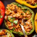 Vegan Stuffed Peppers filled with mushrooms, rice, and veggies. Flavorful, hearty, and ready in under an hour — the perfect meatless dinner! | aheadofthyme.com