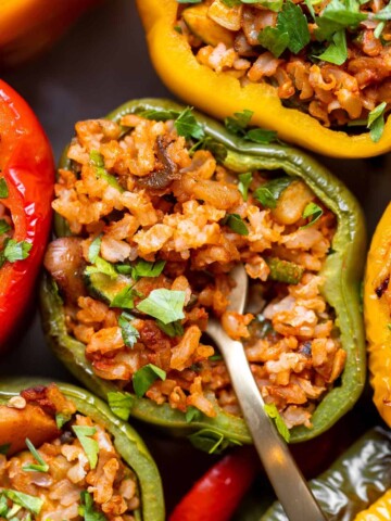 Vegan Stuffed Peppers filled with mushrooms, rice, and veggies. Flavorful, hearty, and ready in under an hour - the perfect meatless dinner! | aheadofthyme.com