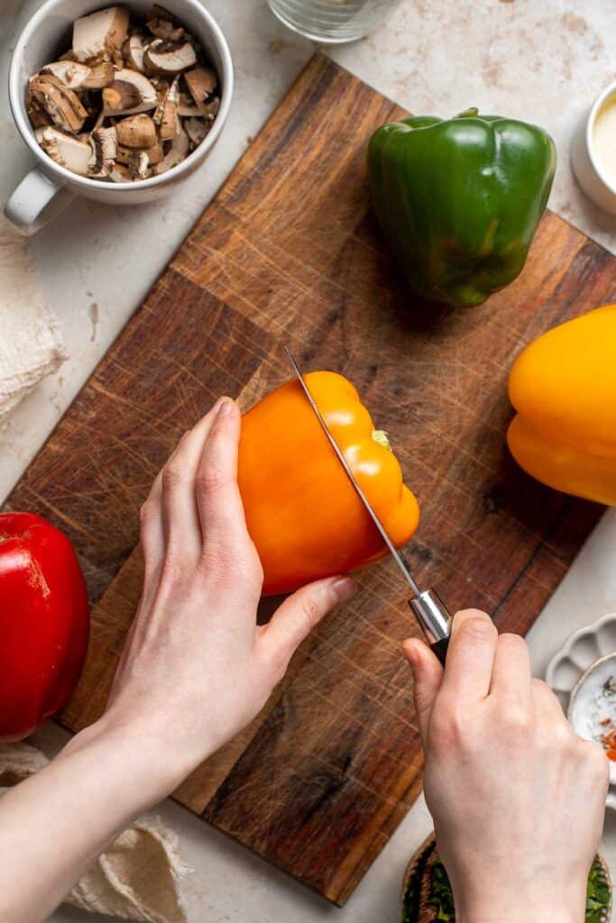 Vegan Stuffed Peppers are stuffed with pan-fried mushrooms, tender rice, and veggies, making them flavorful and filling. Easy to make in under an hour! | aheadofthyme.com