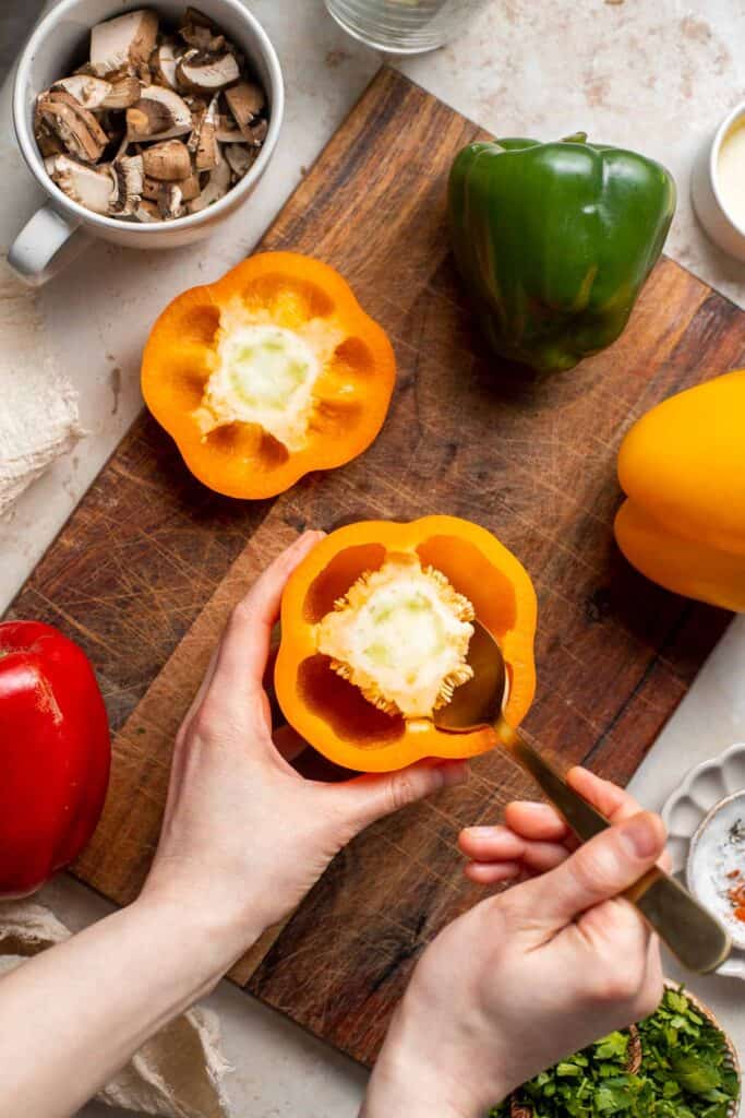 Vegan Stuffed Peppers are stuffed with pan-fried mushrooms, tender rice, and veggies, making them flavorful and filling. Easy to make in under an hour! | aheadofthyme.com