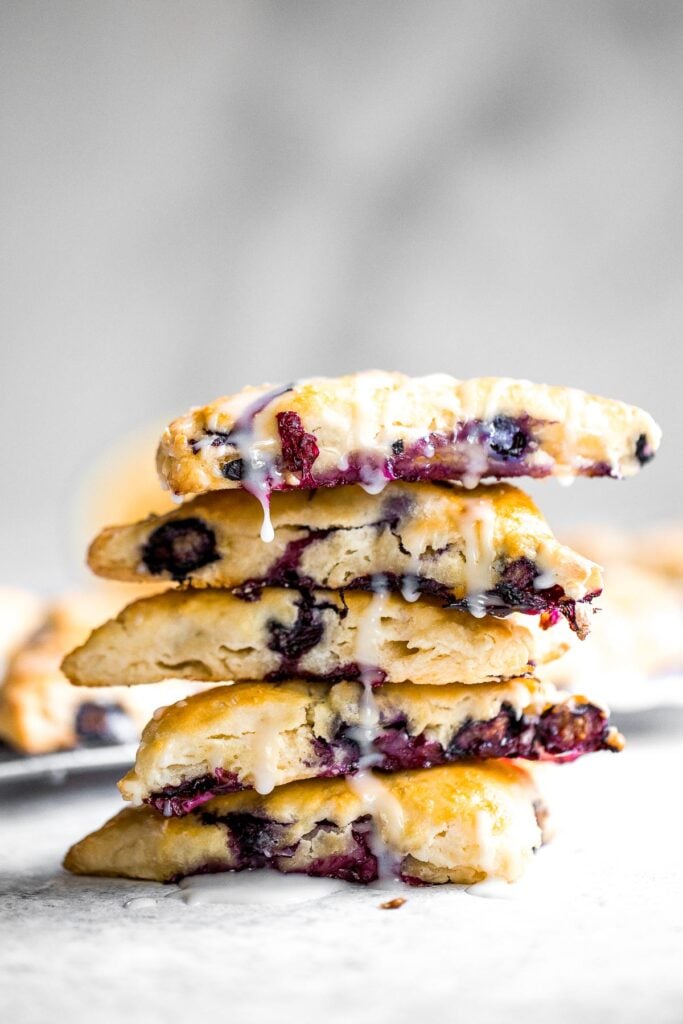 Light, tender and flakey, glazed lemon blueberry scones are crunchy and golden on the outside, soft and moist in the middle, with a drizzle of lemon glaze. | aheadofthyme.com