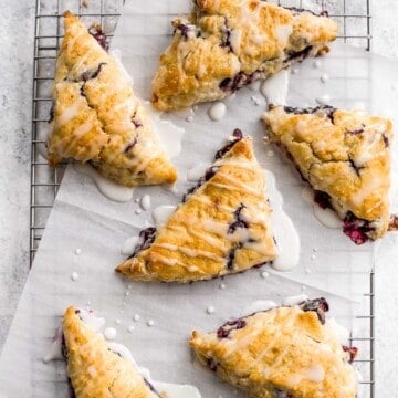 Light, tender and flakey, glazed lemon blueberry scones are crunchy and golden on the outside, soft and moist in the middle, with a drizzle of lemon glaze. | aheadofthyme.com