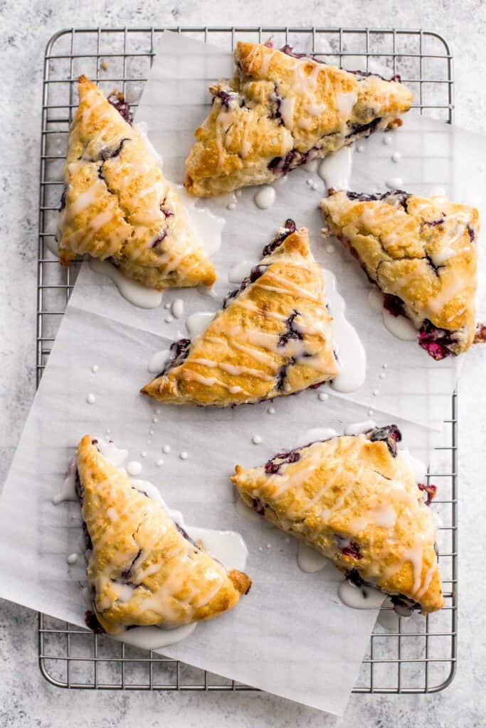 Light, tender and flakey, glazed lemon blueberry scones are crunchy and golden on the outside, soft and moist in the middle, with a drizzle of lemon glaze. | aheadofthyme.com